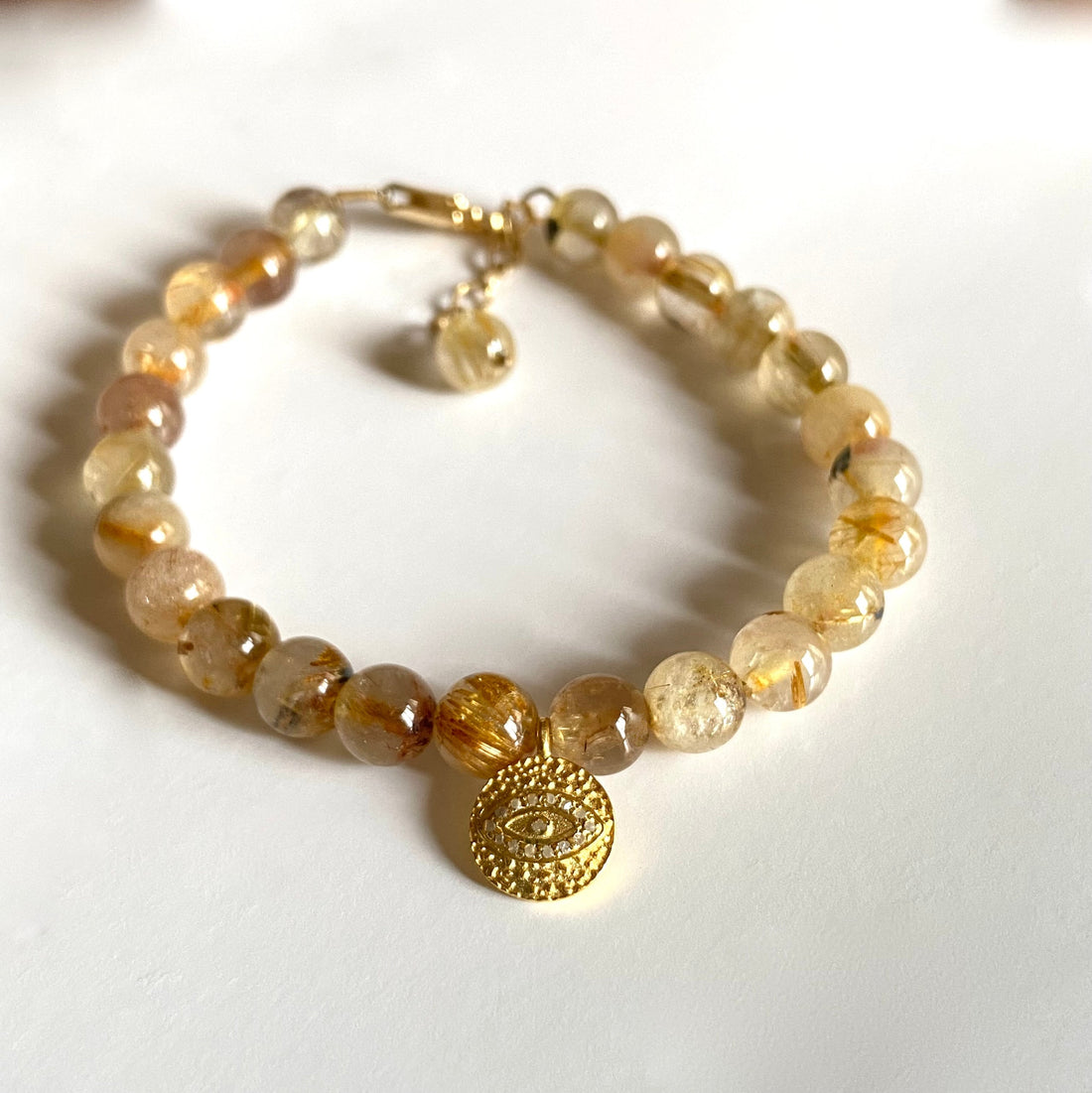 Golden Rutilated Quartz Bracelet with White Diamond Pavé Evil Eye Charm