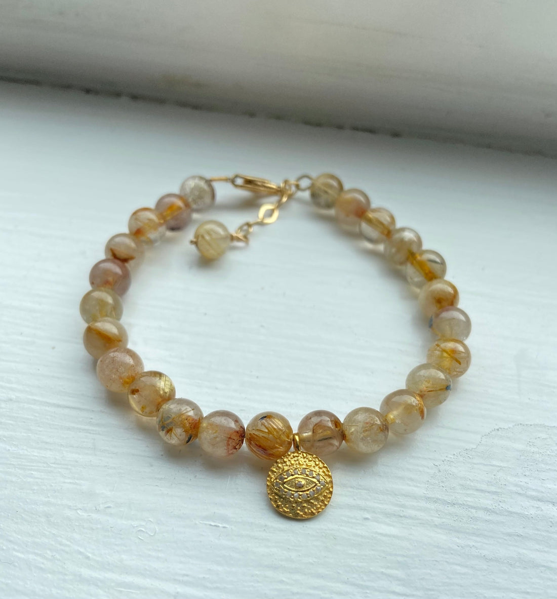 Golden Rutilated Quartz Bracelet with White Diamond Pavé Evil Eye Charm